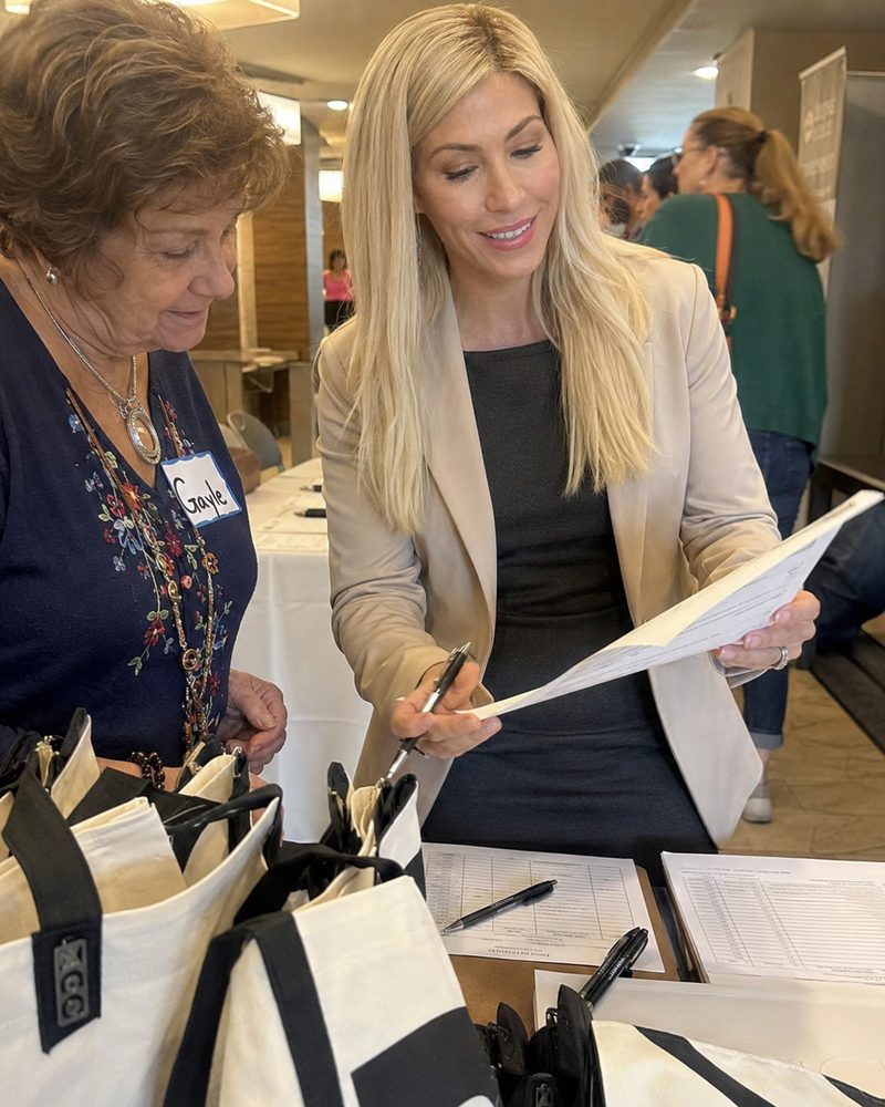 A team member at an owner expo table